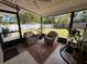 Relaxing screened patio featuring tile floor and comfortable wicker furniture at 1081 Cobblestone Ave, Deltona, FL 32725
