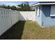 Side yard features a white fence and gate at 1081 Cobblestone Ave, Deltona, FL 32725