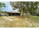 Large backyard features mature trees, a shed, and partially fenced yard with space for entertaining at 1113 Fort Smith Blvd, Deltona, FL 32725