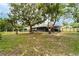 Expansive backyard with mature trees, offering shade and privacy, perfect for outdoor activities at 1113 Fort Smith Blvd, Deltona, FL 32725