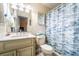 Bright bathroom featuring a white vanity with marble countertops and a blue patterned shower curtain at 1113 Fort Smith Blvd, Deltona, FL 32725
