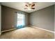 Empty bedroom with neutral walls, carpet flooring, a ceiling fan and natural light at 1113 Fort Smith Blvd, Deltona, FL 32725