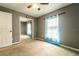 Cozy bedroom featuring a ceiling fan, mirrored closet, and ample natural light through a window at 1113 Fort Smith Blvd, Deltona, FL 32725
