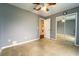 Empty bedroom with neutral walls, carpet flooring, a ceiling fan and a sliding mirrored closet at 1113 Fort Smith Blvd, Deltona, FL 32725