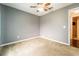 Neutral bedroom with carpet, ceiling fan, and access to an adjacent room at 1113 Fort Smith Blvd, Deltona, FL 32725