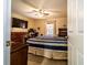 Comfortable bedroom featuring a ceiling fan, television, and a cozy bed with striped bedding at 1113 Fort Smith Blvd, Deltona, FL 32725