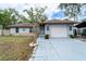 Charming single-story home with a two-car garage, well-maintained landscaping, and inviting curb appeal at 1113 Fort Smith Blvd, Deltona, FL 32725