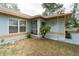 Charming front entrance with colorful siding, decorative wrought iron, and mature landscaping at 1113 Fort Smith Blvd, Deltona, FL 32725
