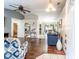 Spacious living room showcasing hardwood flooring and an open floor plan connecting to the kitchen and dining area at 1113 Fort Smith Blvd, Deltona, FL 32725