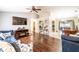 Open-concept living room with hardwood floors, vaulted ceilings, and seamless flow to dining and kitchen areas at 1113 Fort Smith Blvd, Deltona, FL 32725