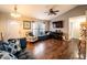 Bright living room features hardwood flooring, a ceiling fan, and a seamless transition to other living spaces at 1113 Fort Smith Blvd, Deltona, FL 32725
