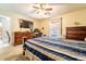 Spacious bedroom with carpet flooring, ceiling fan, TV and doorway at 1113 Fort Smith Blvd, Deltona, FL 32725