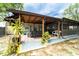 Covered patio with stone pavers and plants, offering a perfect spot for outdoor entertaining at 1113 Fort Smith Blvd, Deltona, FL 32725