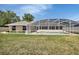 Backyard lawn view with pool area that is enclosed with a screen, plus storage shed at 1142 Glendale Ave, Deltona, FL 32725