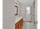 Bathroom features a vanity with wood cabinets and a framed mirror at 1142 Glendale Ave, Deltona, FL 32725