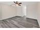 Bedroom featuring ceiling fan, neutral walls, a closet and gray wood flooring at 1142 Glendale Ave, Deltona, FL 32725