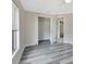 Bedroom with open closet, stylish gray wood-look floors and natural light at 1142 Glendale Ave, Deltona, FL 32725