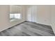 Bedroom features gray wood-look floors and a closet for storage at 1142 Glendale Ave, Deltona, FL 32725