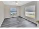 Bedroom boasts stylish gray wood-look floors and natural light from two windows at 1142 Glendale Ave, Deltona, FL 32725