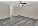 A bedroom featuring neutral walls, ceiling fan, and gray wood flooring at 1142 Glendale Ave, Deltona, FL 32725