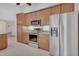 Well-lit kitchen featuring stainless steel appliances and wood cabinetry at 1142 Glendale Ave, Deltona, FL 32725