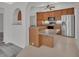 Bright kitchen with stainless steel appliances, wood cabinets and breakfast bar at 1142 Glendale Ave, Deltona, FL 32725