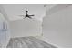 Bright living room with vaulted ceilings, ceiling fan, and modern gray wood flooring at 1142 Glendale Ave, Deltona, FL 32725