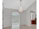 Open-concept room with tile floors, an ornate chandelier, and views into the kitchen at 1142 Glendale Ave, Deltona, FL 32725