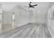 Bright living room with vaulted ceilings, a chandelier, gray wood flooring, and tile entryway at 1142 Glendale Ave, Deltona, FL 32725