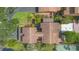 Aerial view of a well-maintained house with manicured landscaping, a tennis court and a backyard pool at 115 Oaks Ct # 115, Sanford, FL 32771
