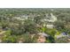 Aerial view showcasing the community tennis courts and mature trees of this well-maintained neighborhood at 115 Oaks Ct # 115, Sanford, FL 32771