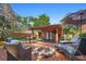 Outdoor entertaining space with a fire pit, covered deck, and lush landscaping create a relaxing backyard retreat at 115 Oaks Ct # 115, Sanford, FL 32771