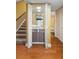 Cozy bar area next to a staircase, featuring a sink, mirror, and storage, with bathroom access at 115 Oaks Ct # 115, Sanford, FL 32771