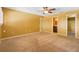 Large bedroom with an ensuite bathroom, carpet, light colored walls, and a ceiling fan at 115 Oaks Ct # 115, Sanford, FL 32771