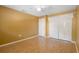 Bright bedroom featuring wood floors, a ceiling fan, and a spacious closet with folding doors at 115 Oaks Ct # 115, Sanford, FL 32771