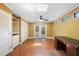 Bright room with hardwood floors, ceiling fan, skylight, built-in storage, and outdoor access at 115 Oaks Ct # 115, Sanford, FL 32771