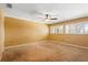 Bedroom with light walls, carpet, plantation shutters on the windows, and a ceiling fan at 115 Oaks Ct # 115, Sanford, FL 32771