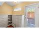 Walk-in closet features built-in shelves and drawers for maximum storage with natural light at 115 Oaks Ct # 115, Sanford, FL 32771