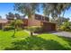 Inviting two-story home with a well-manicured lawn and mature trees providing shade, offering a classic curb appeal at 115 Oaks Ct # 115, Sanford, FL 32771