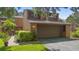 Charming home with a two-car garage, complemented by lush landscaping and mature trees at 115 Oaks Ct # 115, Sanford, FL 32771