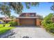 Charming two-story home with a garage, complemented by a neatly maintained lawn and mature landscaping at 115 Oaks Ct # 115, Sanford, FL 32771