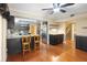 Open-concept kitchen features dark cabinets, stainless steel appliances, granite countertops, and hardwood flooring at 115 Oaks Ct # 115, Sanford, FL 32771