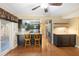 Eat-in kitchen with wooden floors, granite countertops, dark cabinets, stainless steel appliances, and barstool seating at 115 Oaks Ct # 115, Sanford, FL 32771