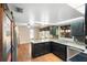 Kitchen featuring dark cabinetry, granite countertops, stainless steel appliances, hardwood floors, and a breakfast nook at 115 Oaks Ct # 115, Sanford, FL 32771