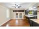 Sun-filled kitchen offers dark cabinetry, granite countertops, stainless steel appliances, and French door access to the porch at 115 Oaks Ct # 115, Sanford, FL 32771