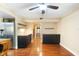Open layout offers eat-in kitchen with dark cabinets, granite countertops, stainless steel appliances, and hardwood floors at 115 Oaks Ct # 115, Sanford, FL 32771
