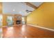 Bright living room with hardwood floors, a stone fireplace, large windows, and a ceiling fan at 115 Oaks Ct # 115, Sanford, FL 32771