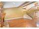 Bright living room featuring hardwood floors, a stone fireplace, high ceilings, and a staircase at 115 Oaks Ct # 115, Sanford, FL 32771