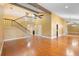 Spacious living room featuring high ceilings, a staircase, and hardwood floors, filled with natural light at 115 Oaks Ct # 115, Sanford, FL 32771