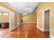 Inviting living room showcasing hardwood floors, a stone fireplace, and an elegant chandelier lighting at 115 Oaks Ct # 115, Sanford, FL 32771